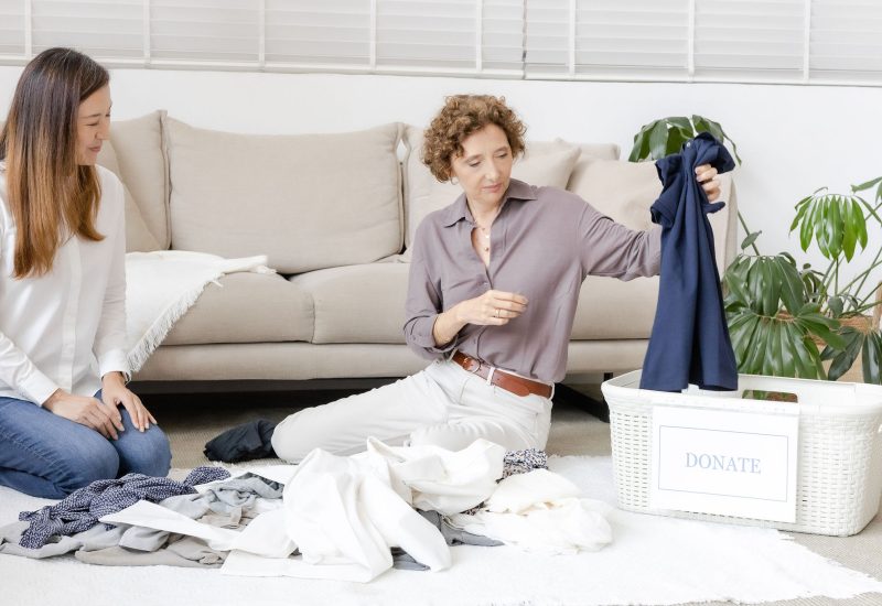 Iterative decluttering process showing an item being placed in a donation basket